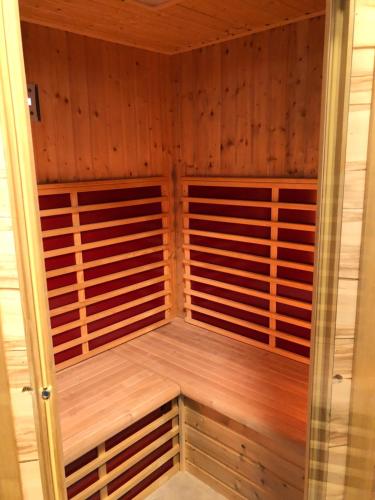 a sauna with wood paneling and a glass door at Appartement Antretter in Angerberg