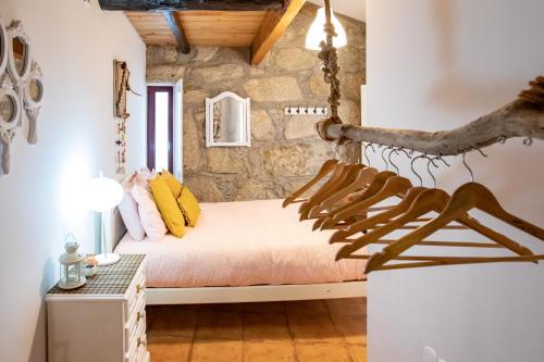 a bedroom with a bed in a stone wall at Red House- Historic center in Porto