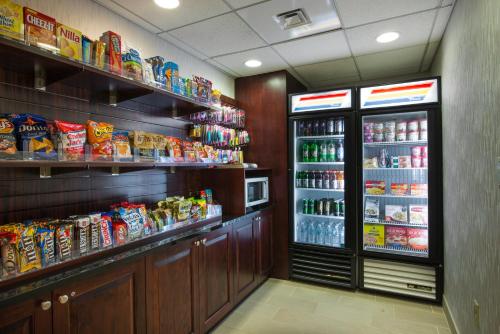 a grocery store with a refrigerator and lots of food at Holiday Inn Express Hotel & Suites Philadelphia - King of Prussia by IHG in King of Prussia