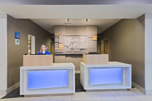 a woman standing in a room with two boxes at Holiday Inn Express & Suites Tavares by IHG in Tavares