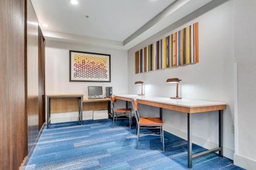a waiting room with a desk and chairs at Holiday Inn Express Hotel & Suites Lake Elsinore by IHG in Lake Elsinore