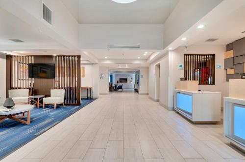 an empty lobby of a hospital with chairs and tables at Holiday Inn Express Hotel & Suites Lake Elsinore by IHG in Lake Elsinore
