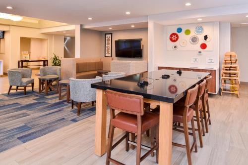 a waiting room at a hospital with a table and chairs at Holiday Inn Express & Suites Lacey - Olympia by IHG in Lacey