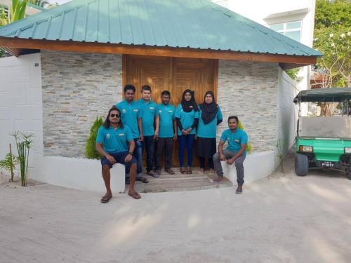 a group of people standing in front of a house at PERLA Dhangethi in Dhangethi