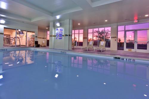 a swimming pool with blue lights in a building at Holiday Inn & Suites Bakersfield, an IHG Hotel in Bakersfield