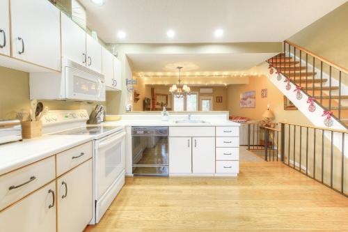 a large kitchen with white cabinets and a staircase at Leinemann Ski Haus in McHenry