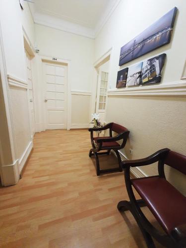 a hallway with two chairs and a table in a room at MIDIS - Local Accommodation in Lisbon