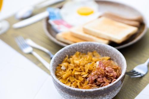 a bowl of food on a table with eggs and toast at PERLA Dhangethi in Dhangethi