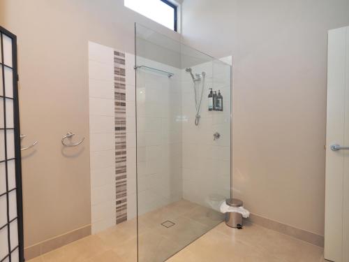 a shower with a glass door in a bathroom at The Lodges Two in Halls Gap