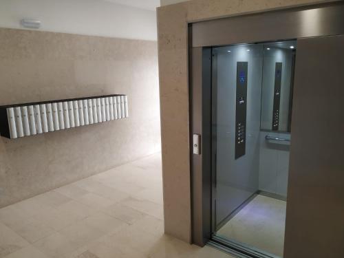 an elevator in a building with a glass door at apartamento La Coqueta in Santander