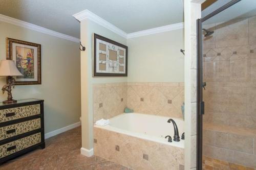 a large bathroom with a tub and a shower at TOPS'L Tides III in Destin