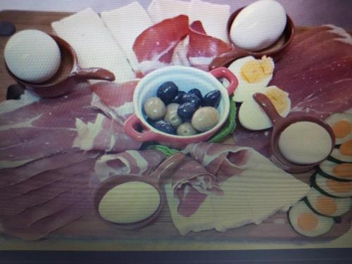 a table with a plate of food with a pair of scissors at Guest House RG in Žabljak