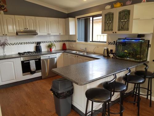a kitchen with a fish tank on the counter at Sundowner Cottage in Sanctuary Point