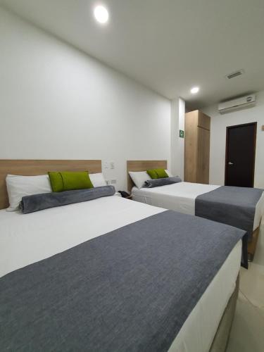 A bed or beds in a room at Hotel Laureles Park