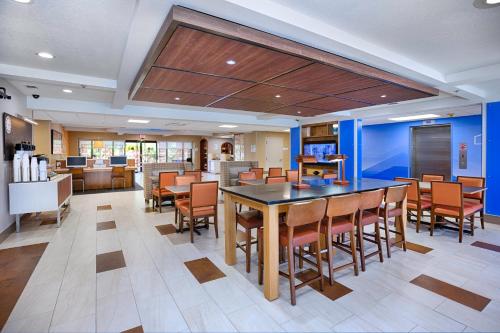 a dining room with a table and chairs at Holiday Inn Express Hotel & Suites Jacksonville-South by IHG in Jacksonville