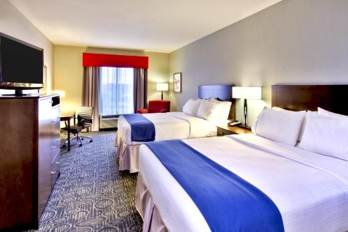 a hotel room with two beds and a flat screen tv at Holiday Inn Express & Suites Oak Ridge by IHG in Oak Ridge
