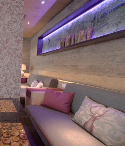 a living room with a couch and a painting on the wall at Wolfs Aparts + More in Ischgl