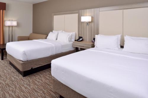 two beds in a hotel room with white pillows at Holiday Inn Express & Suites Williams by IHG in Williams