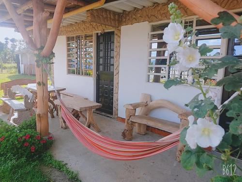 a hammock on the porch of a house at Cabañas Guacari San Agustín huila in San Agustín
