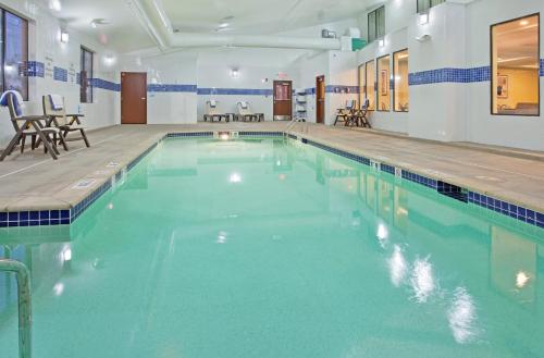 a large swimming pool with blue water in a building at Holiday Inn Express Hotel & Suites St. Charles, an IHG Hotel in St. Charles