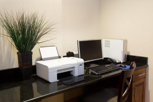 a desk with a computer and a printer on it at Holiday Inn Express Hotel & Suites Silt - Rifle by IHG in Silt