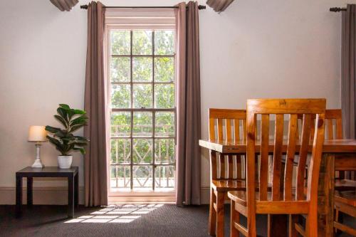 a room with a large window and a table and chairs at The Globe Hotel, Rylstone in Rylstone
