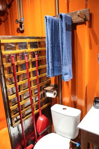 a bathroom with a toilet and blue towels at House Boat "Faroeste Caboclo" in Brasília