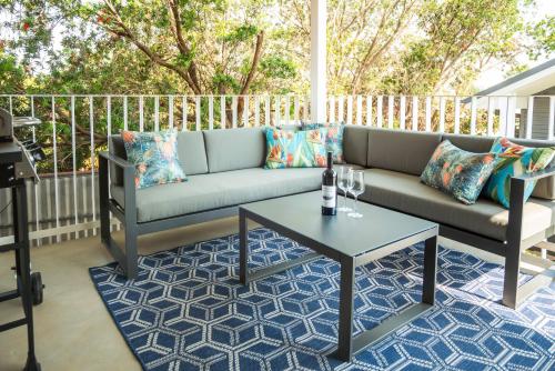 a couch on a patio with a table at Kirsten Accommodation Parkes in Parkes