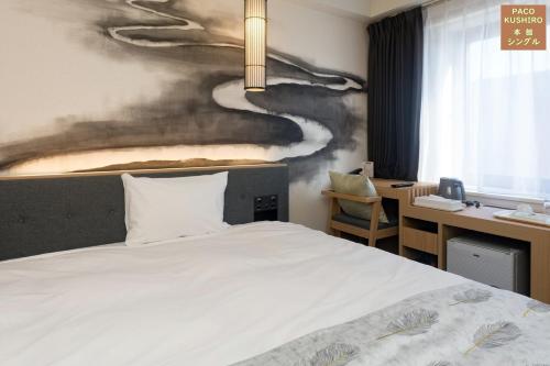 Cama ou camas em um quarto em Hotel Global View Kushiro