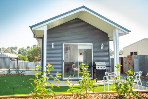 a grey tiny house with a patio at Kirsten Accommodation Parkes in Parkes