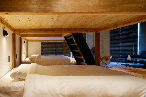 a bedroom with two beds and a loft bed at mizuka Nakasu 5 - unmanned hotel - in Fukuoka