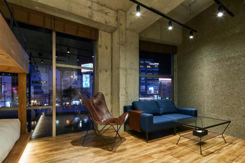 a living room with a couch and a table at mizuka Nakasu 5 - unmanned hotel - in Fukuoka
