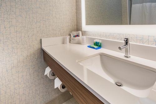 a white bathroom with a sink and a mirror at Holiday Inn Express Hotel & Suites Swansea by IHG in Swansea