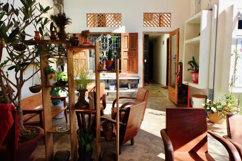 a room with chairs and a table with plants at The Kadupul Homecation in Da Lat