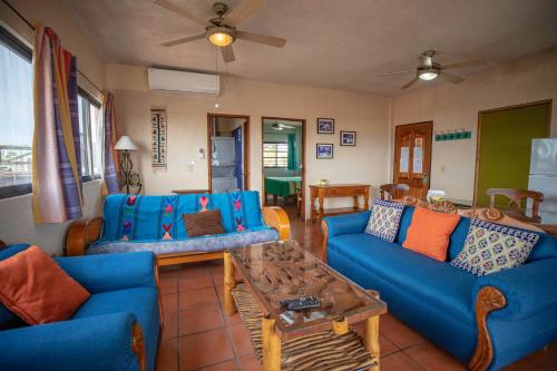 a living room with blue couches and a coffee table at Hotel Posada Luna Sol in La Paz