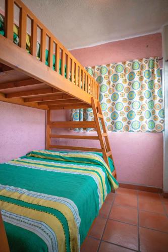 a childs bedroom with a bunk bed and a staircase at Hotel Posada Luna Sol in La Paz