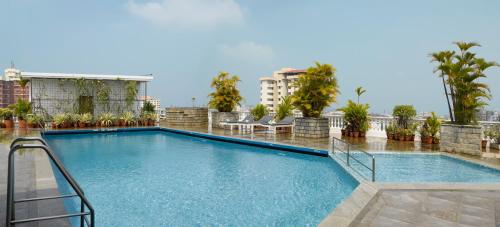 a swimming pool on top of a building at Abad Atrium in Cochin