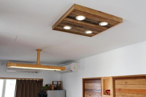 a ceiling with three lights on a room at Summerflow Hostel in Xiaoliuqiu