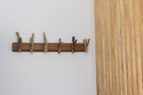 a wooden shelf on a white wall at Summerflow Hostel in Xiaoliuqiu