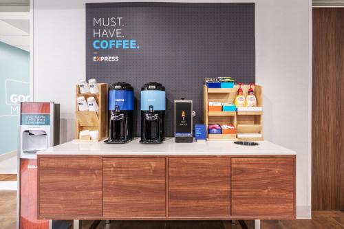 a counter in a coffee shop with bottles of coffee at Holiday Inn Express & Suites Lake Havasu - London Bridge by IHG in Lake Havasu City