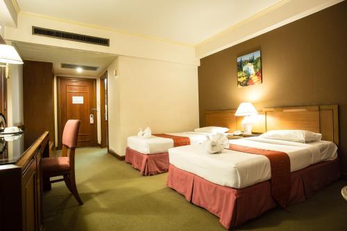 Ένα ή περισσότερα κρεβάτια σε δωμάτιο στο Songphanburi Hotel