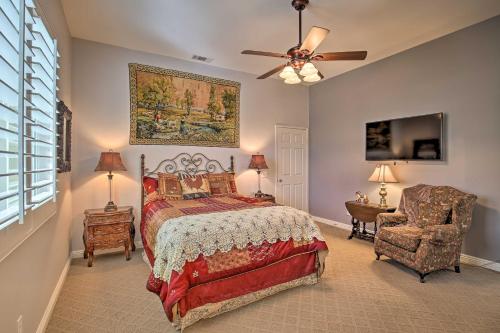 a bedroom with a bed and a fan and a chair at Indio Casita 2 Mi to Coachella and Stage Coach! in Indio