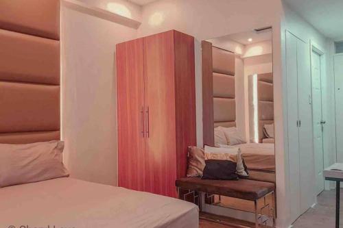 a bedroom with two beds and a red cabinet at CoffeeSummer Spaces Studio 211 Near Mactan Airport in Mactan