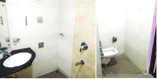 a bathroom with a sink and a toilet at Abimon Residency Kollur in Kollūru