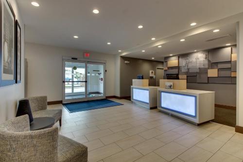 a lobby of a store with chairs and a counter at Holiday Inn Express & Suites Ithaca by IHG in Ithaca