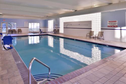 a large swimming pool with blue water in a building at Holiday Inn Express Hotel & Suites Idaho Falls by IHG in Idaho Falls