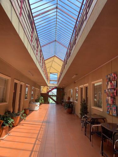 an empty hallway in a building with a glass ceiling at City East Motel in Melbourne