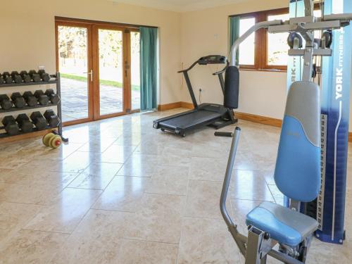 a gym with a treadmill and a exercise bike at Manor House in Chesterfield