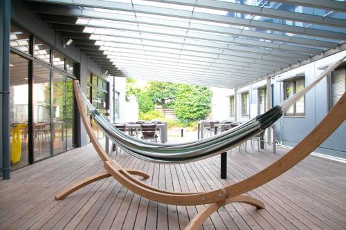 a hammock on a deck in a building at Narita AIC Airport Hotel in Narita