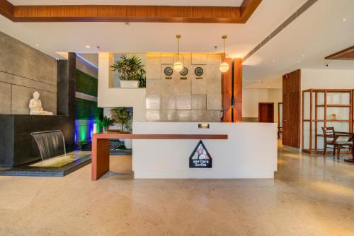 a lobby with a table and chairs in a room at Amritara Sadka Amritsar in Amritsar